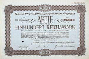 Alte deutsche Aktie über einhundert Reichmark mit schwarzem Rand und gedrucktem Text.