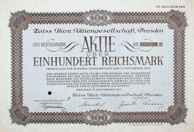 Alte deutsche Aktie über einhundert Reichmark mit schwarzem Rand und gedrucktem Text.