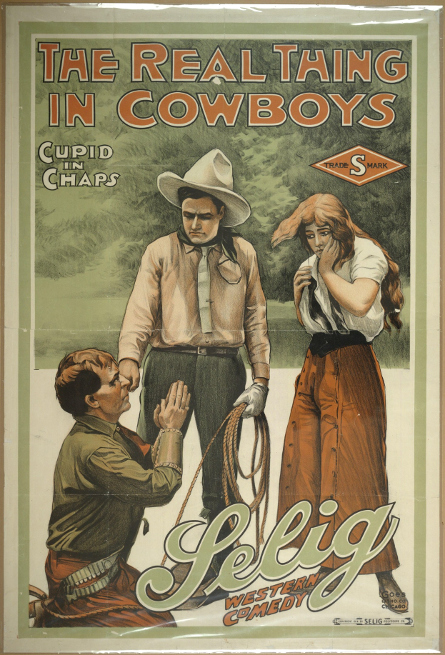 Plakat an einer Wand mit drei Personen in Cowboy-Kleidung und "The Real Thing in Cowboys" darüber, vor einem gelben Hintergrund.