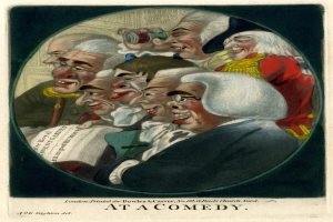 Eine Gruppe von Menschen, die in einem Kreis stehen, einer hölt ein Blatt Papier und lächelt auf einer Comedy-Veranstaltung.